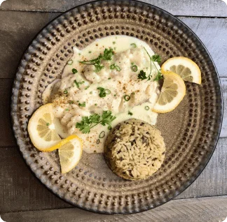 A plate of chicken with lemons and rice